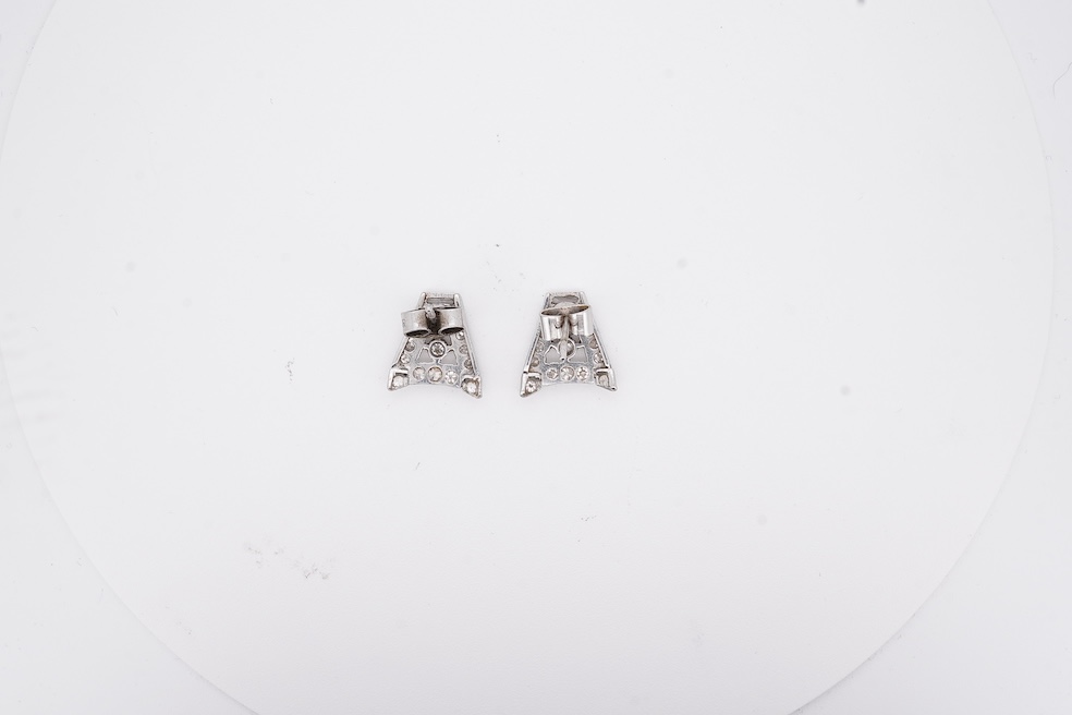 A pair of mid 20th century white metal and millegrain set diamond cluster set 'A' shaped ear studs(adapted from watch lugs?), set with round and baguette cut stones, 12mm, gross weight 3.2 grams.